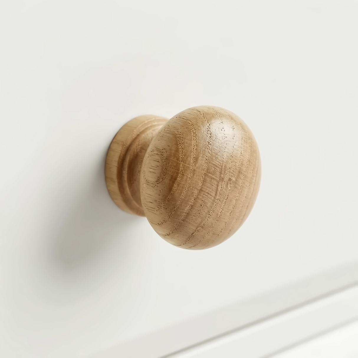 [White] Haven bedside table close-up of turned wooded round drawer knob with natural oak grain detail