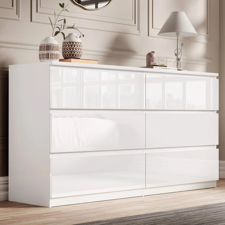 [White] High gloss 6 drawer chest of drawers in elegant bedroom with panelled wall and vases.