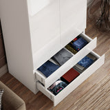 two bottom drawers of white high gloss wardrobe pulled out showing folded clothes in vibrant colours