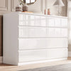[white] high gloss 8 drawer chest in bedroom with panelled wall mirror and decorative vases on top