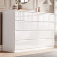[white] high gloss 8 drawer chest in bedroom with panelled wall mirror and decorative vases on top