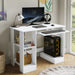 White computer desk with a monitor, keyboard, and other accessories in a room with a window.