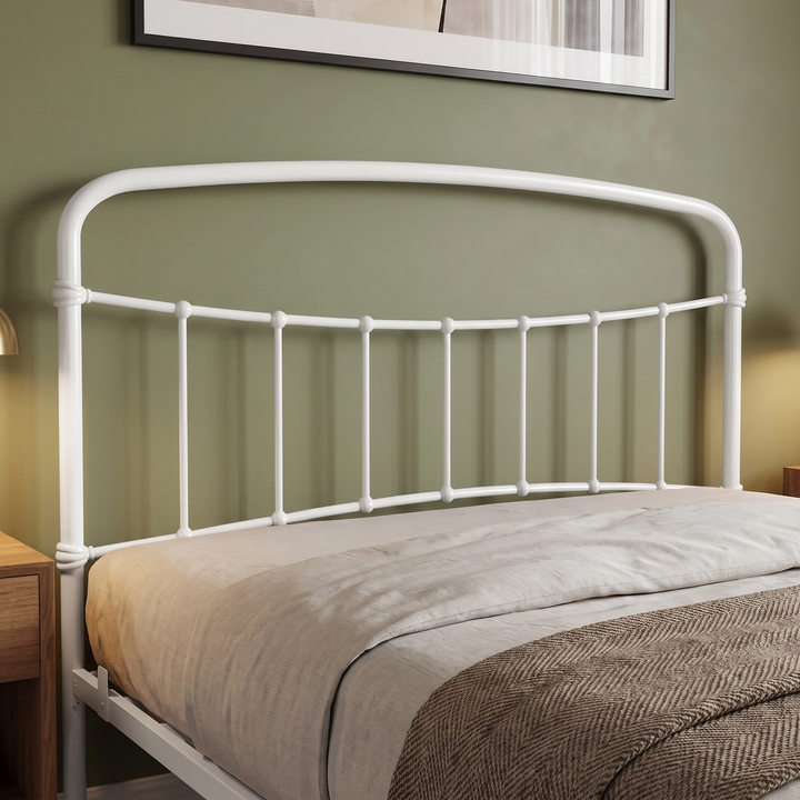[White | King] Headboard detail showing a curved tubular top rail, vertical bars, decorative collars, bedding, and throw.