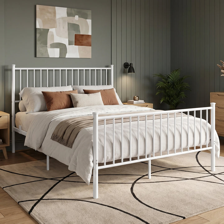 [White | King] Angled bed view showing vertical bars, rust cushions, a fringed throw, wall lamp, plant, and patterned rug.