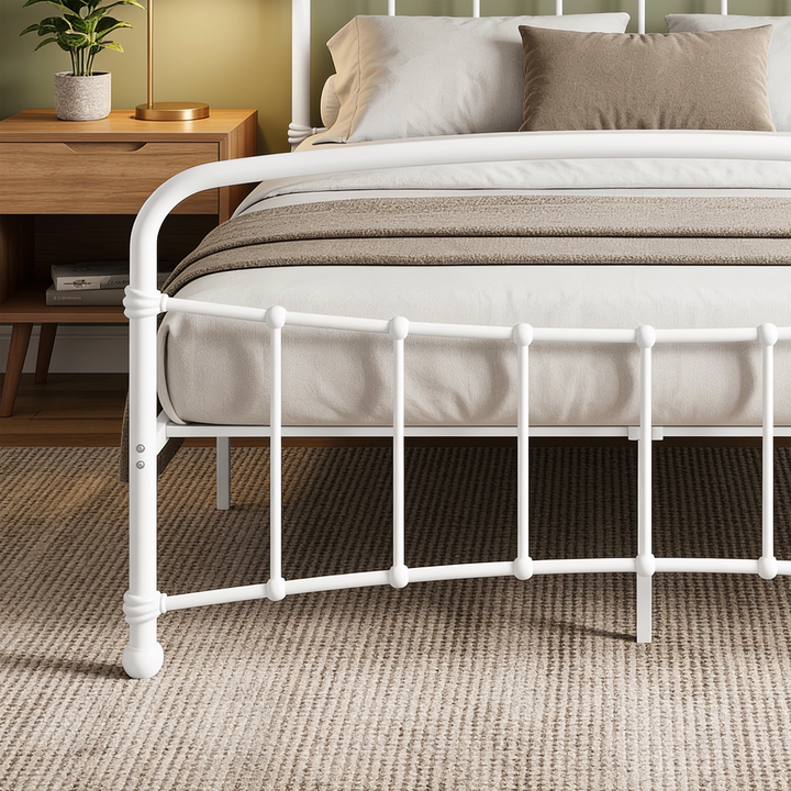 [White | King] Footboard close-up showing a curved top rail, vertical spindles, decorative joints, bolts, and rounded foot.