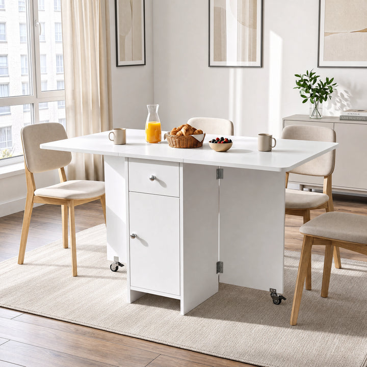 [White] Kitchen drop leaf table fully open and locked via caster supports styled with four chairs, orange juice and mugs.