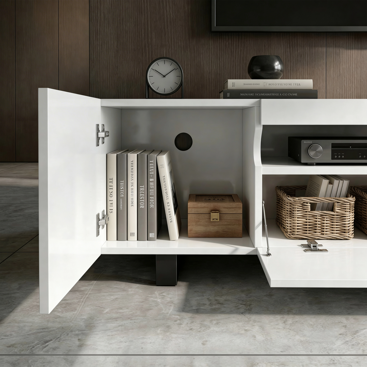 [White] Kystra TV stand left cabinet door open close-up, showing internal shelf with books, a wooden keepsake box, chrome hinges, and a round cable routing hole in the cabinet back panel
