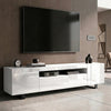 [White] Kystra TV unit in a contemporary living room against a dark wood wall, with two side cabinets, a centre open shelf, black metal legs, and decorative accessories on top