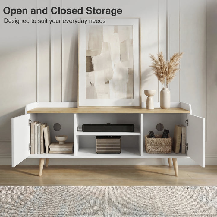 [White | 112 cm] Larvik front view with both doors open revealing books, soundbar, speaker, woven basket, and cable holes in panelled room