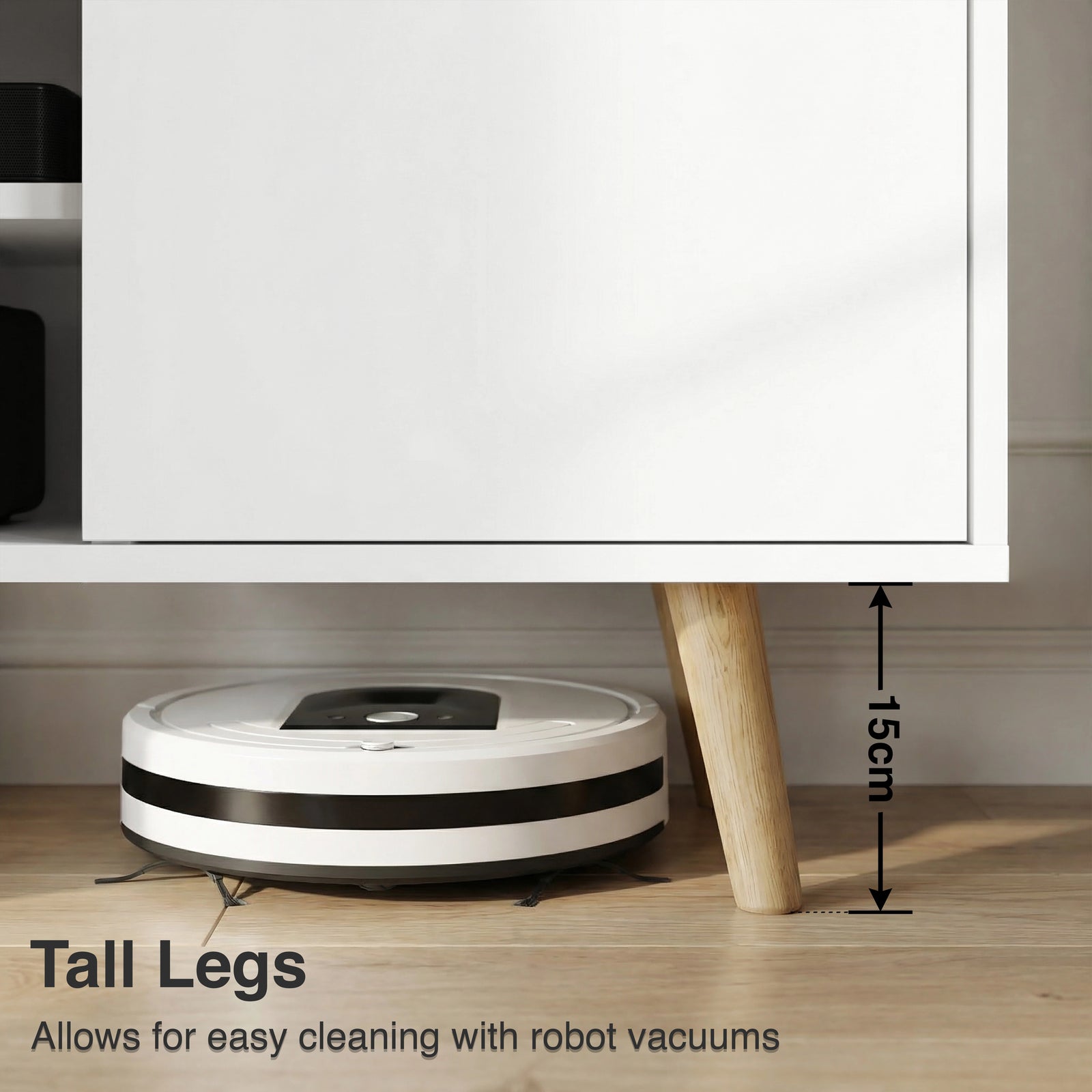 [White | 112 cm] Larvik close-up of 15cm tapered oak legs with robot vacuum passing underneath on wooden floor in grey-toned room