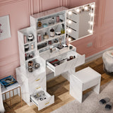 White vanity table with mirror and storage compartments in a room with pink walls.