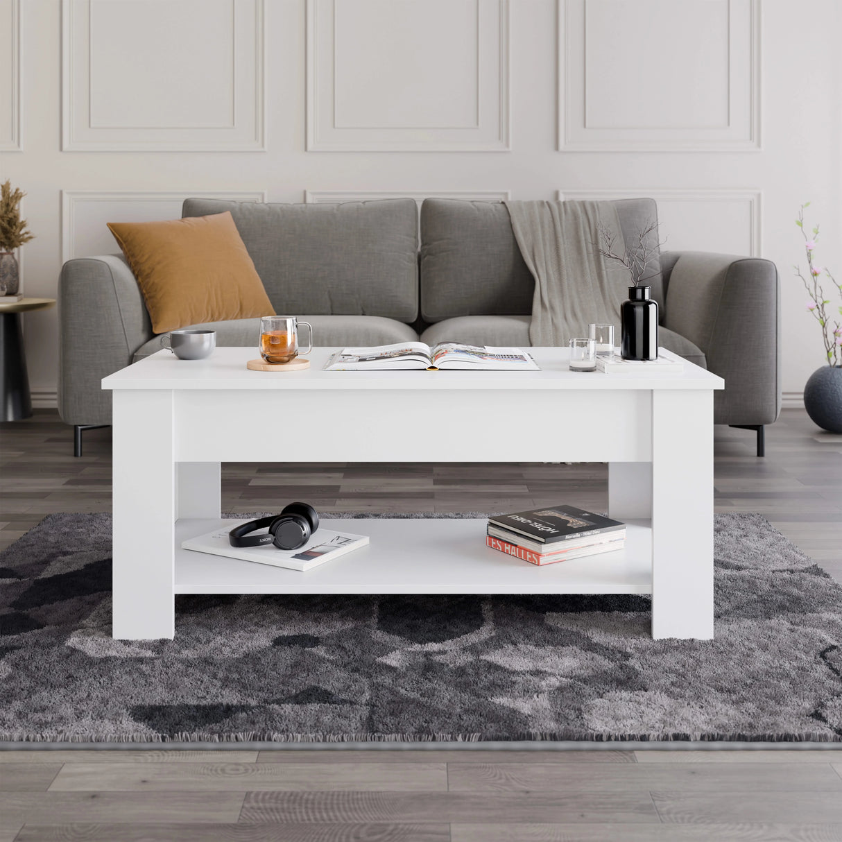 [White] Lift top coffee table closed front view in white with book and candle on top.