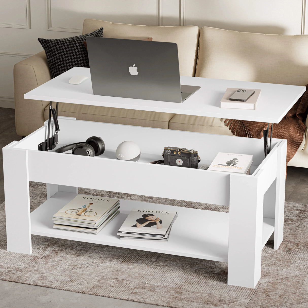 [White] Lift top coffee table raised with laptop showing hidden storage with headphones.