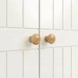 [White] cabinet doors with wooden knobs on a white tiled wall background