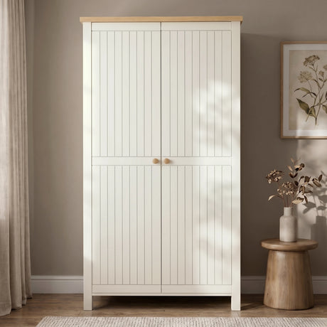 [White] 2 Door wardrobe with oak wood top and in a room with a plant and vase on a small table