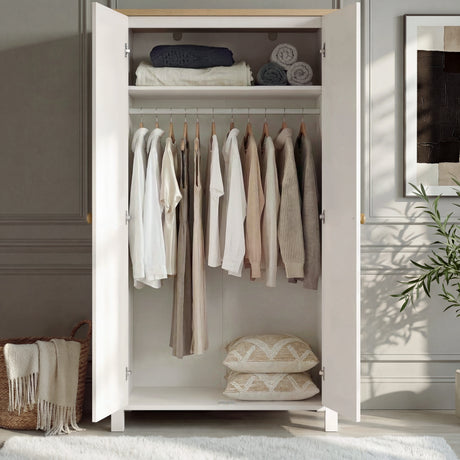 [White] Linra 2 Door Wardrobe open interior showing upper shelf with folded textiles, hanging rail with garments, and floor storage