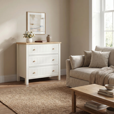[White] Living space Linra chest of drawers with beige sofa set beside the wall and a center table