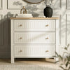 [White] Linra chest of drawers front view with oak top styled with vase, blossom stems, books in sunlight