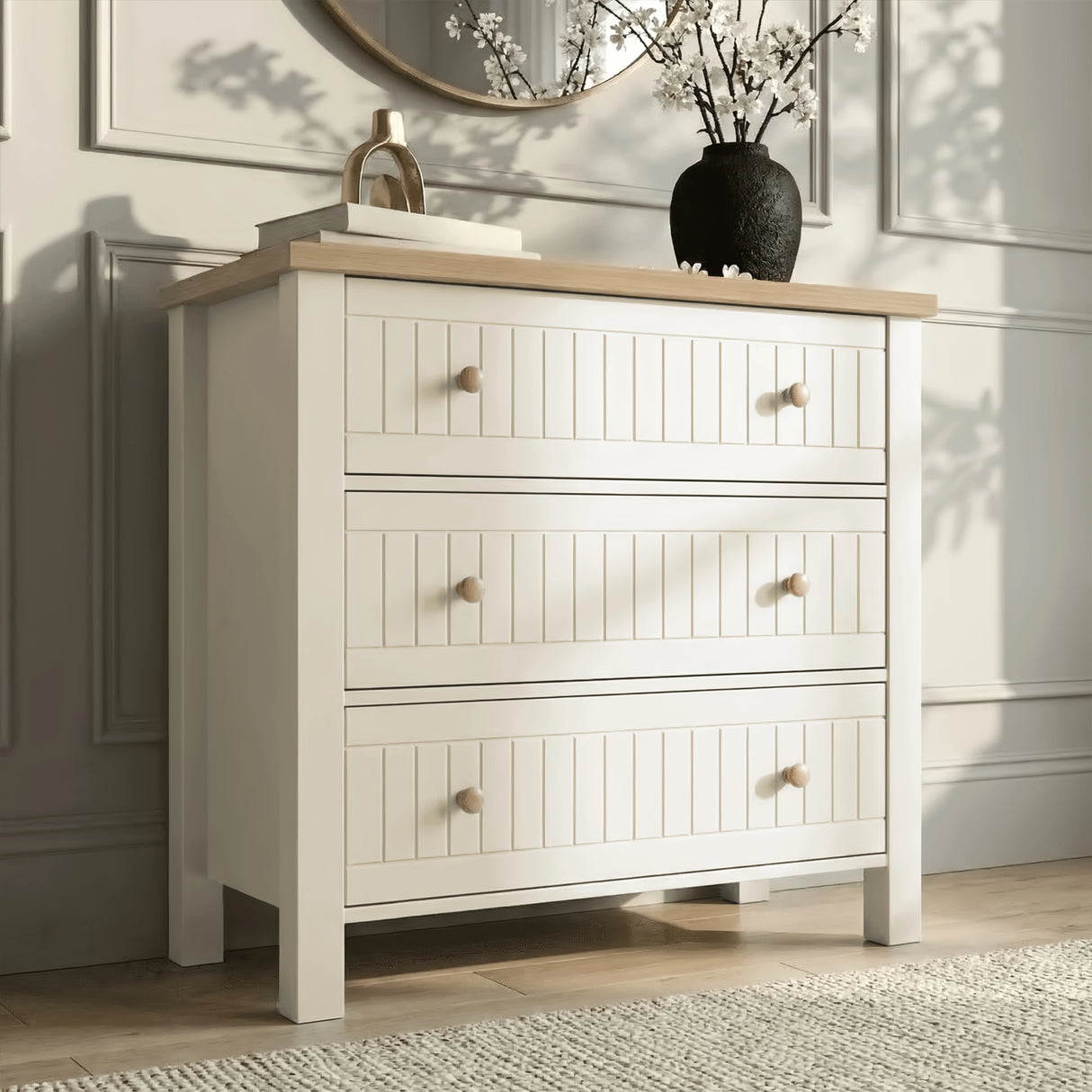 [White] Linra chest of drawers in white with round gold mirror above and stems on oak top