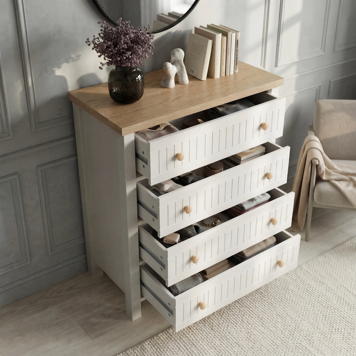 [White] Linra 4-drawer chest of drawers with all drawers open revealing interior storage and decorative items on top
