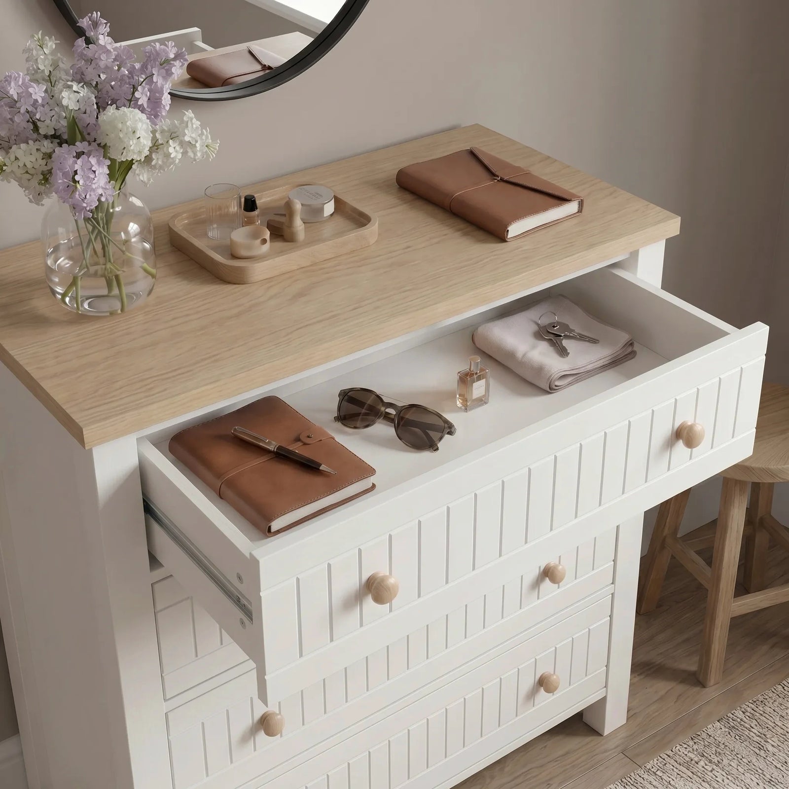 [White] Linra 4 drawer chest with all four drawers open at an angle revealing stored accessories, folded clothes, and jewellery in bedroom setting
