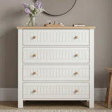 [White] Linra 4 drawer chest front view with oak top styled with dried floral vase, sculptural ornament, and books below a round black mirror