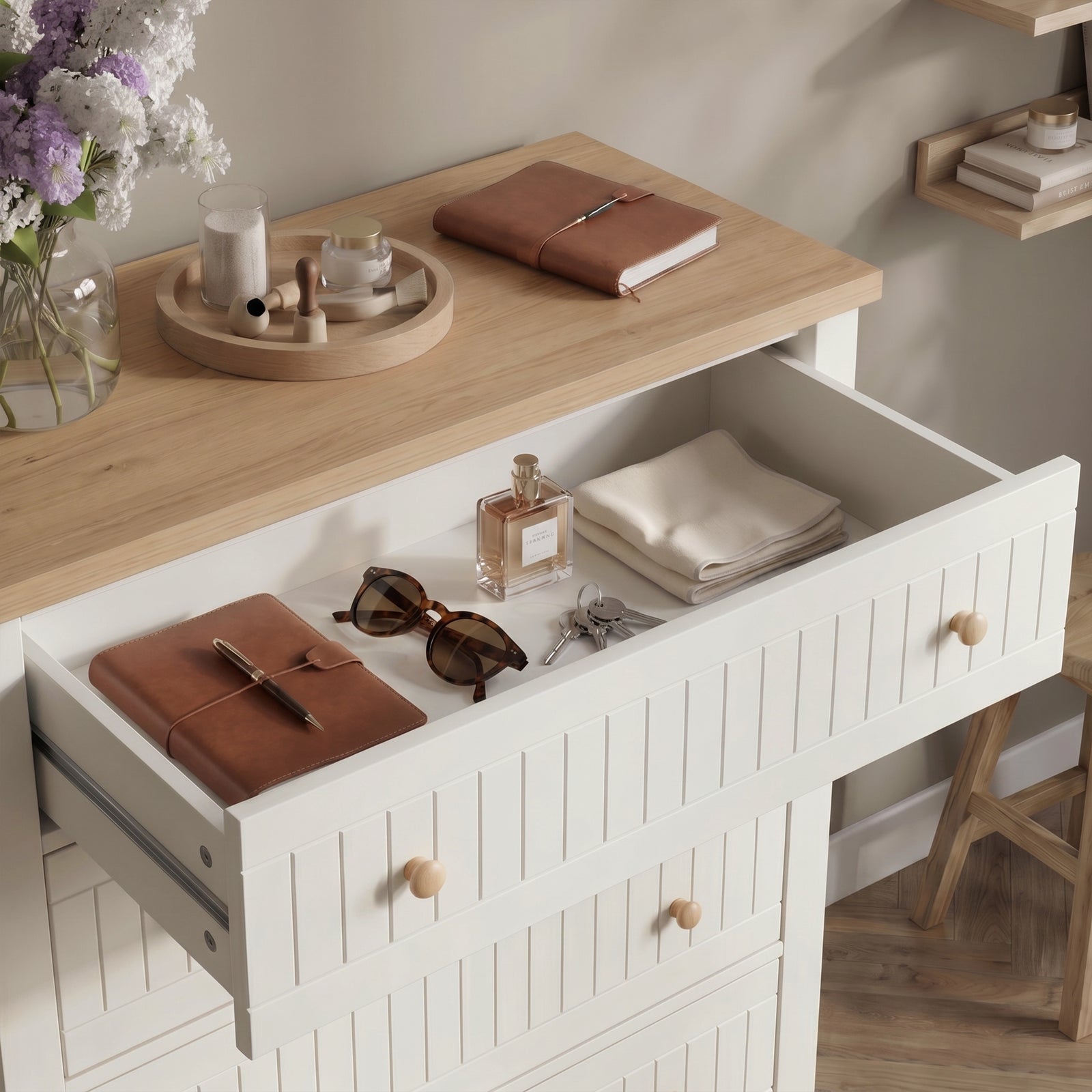 [White] Linra tall 5 drawer chest with all five drawers open at an angle showing stored folded clothing and accessories against wall