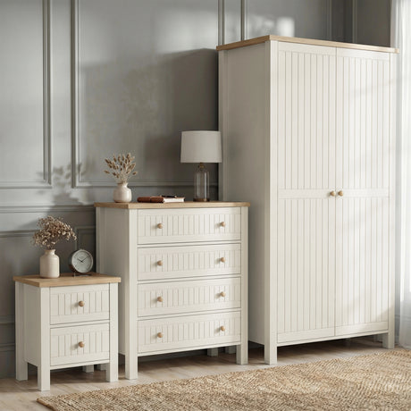 [White] Linra wardrobe, 4 drawer chest, and 2 drawer bedside grouped on grey panelled wall with table lamp and vase