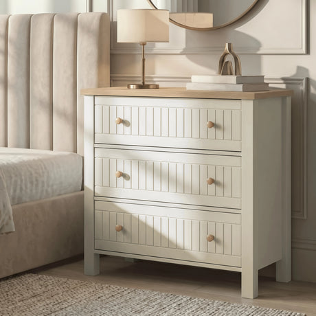 [White] Bedroom Linra chest of drawers in white with table lamp glowing and accessories on oak surface