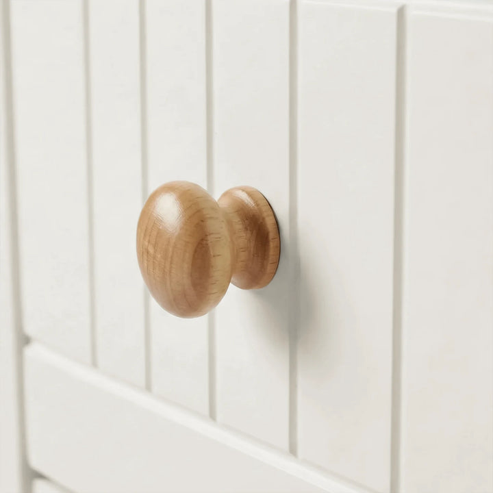 [White] Linra chest of drawers close-up of natural oak rounded wooden knob on grooved painted drawer front