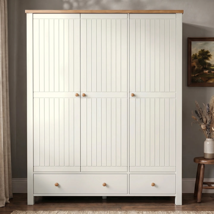 [White] Linra Painted 4 Piece Bedroom Furniture Set triple wardrobe front view with beadboard doors, oak top, round knobs, and two base drawers