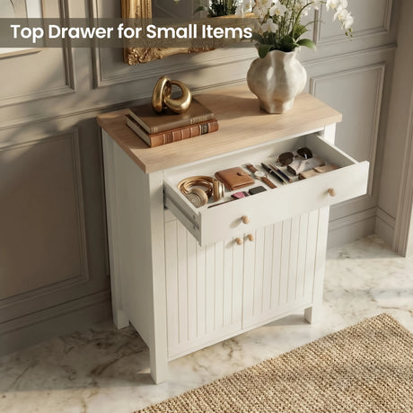 [White] Linra shoe cabinet with top drawer open storing headphones, wallet, watch, sunglasses, and pens on oak surface with decorative vase