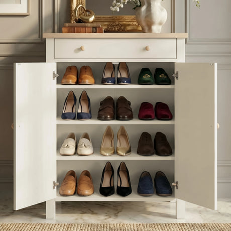 [White] Linra shoe cabinet with both doors fully open showing four shelves holding twelve pairs of heels, loafers, and dress shoes in hallway