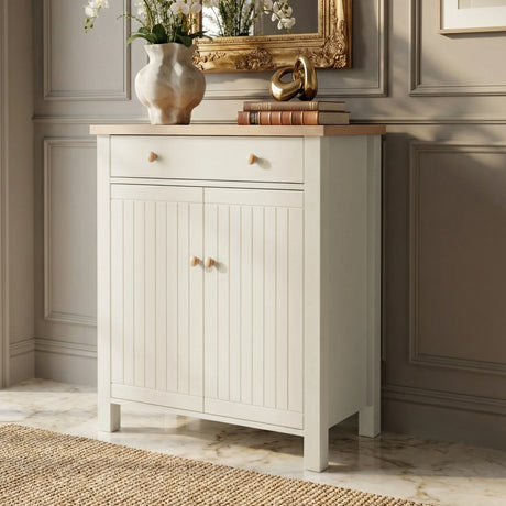 [White] Linra shoe cabinet front view in hallway with oak top styled with orchid vase, leather-bound books, and gold ornament against panelled wall