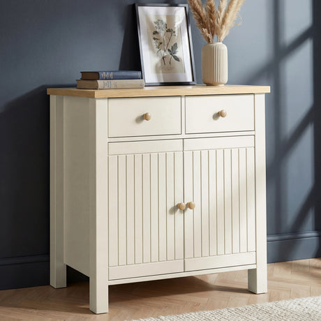 [White] Linra sideboard in a hallway living space styled with ceramic lamp, decorative vases, stacked books, and gallery wall artwork