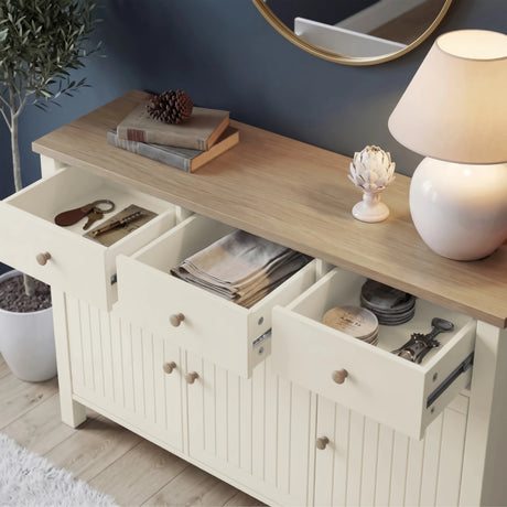 [White] Linra 3 door sideboard with three drawers open at an angle showing interior depth storing keys, linens, coasters, and small accessories