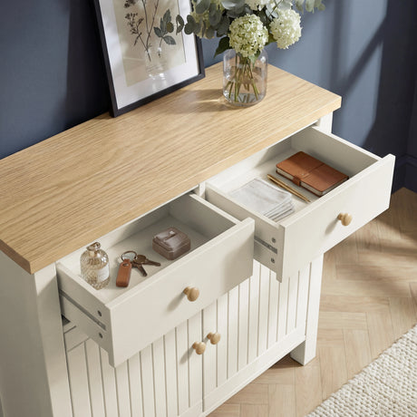 [White] Linra sideboard with two drawers open showing interior storage depth, holding keys, jewellery, notebooks, and folded cloths