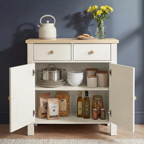[White] Linra sideboard with doors open revealing two adjustable shelves storing pots, bowls, ceramic canisters, pasta, coffee, and olive oil