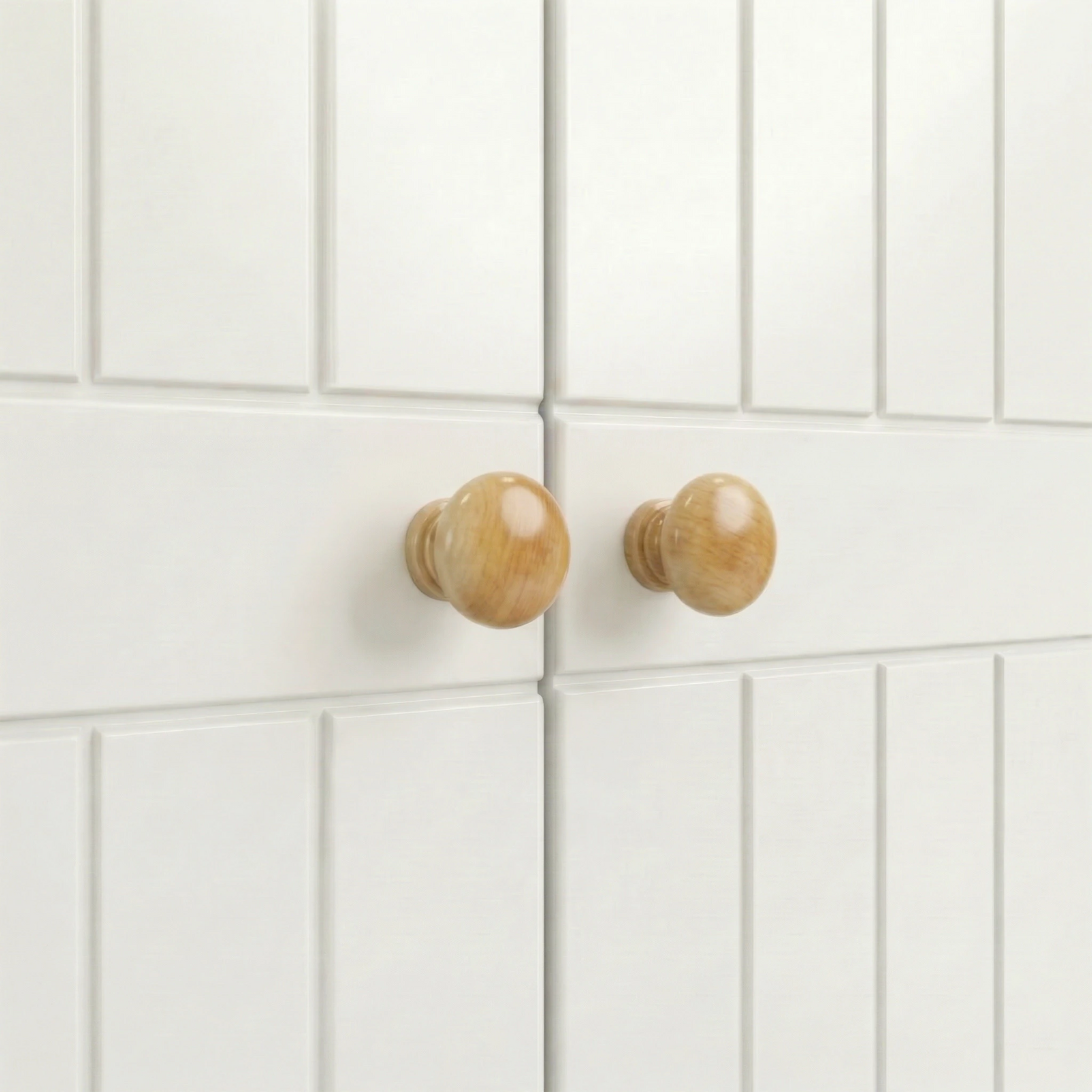[White] Linra close-up showing round wooden door knobs, beaded door panels, centre join, and painted frame detail.