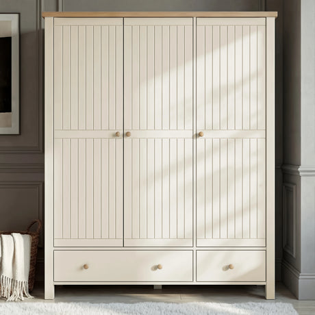[White] Front view of the Linra bedroom furniture set wardrobe, three painted doors and lower drawers, wood knobs