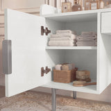 White dressing vanity table with open shelves displaying neatly arranged storage baskets and towels