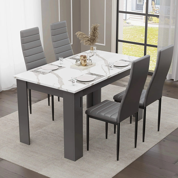 [4 Seater | Grey] white marble dining table with four grey ribbed high-back chairs and place settings by window