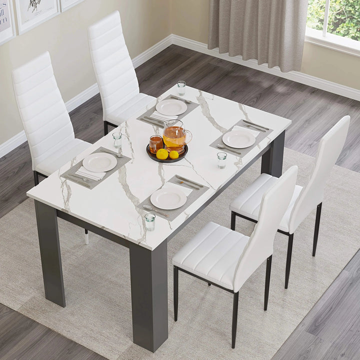 [4 Seater | White] overhead shot of marble dining table with four white chairs and central bowl of fruit