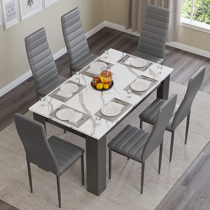 [6 Seater | Grey] overhead shot of marble dining table with six grey chairs and central bowl of fruit
