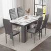 elegant marble dining table and 6 chairs set in grey and white with black leather chairs, modern vibe