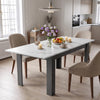 [White Marble] Closed marble-effect dining table styled with fruit, flowers and candles; beige chairs stand by its grey legs.