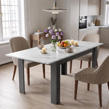 [White Marble] Closed marble-effect dining table styled with fruit, flowers and candles; beige chairs stand by its grey legs.