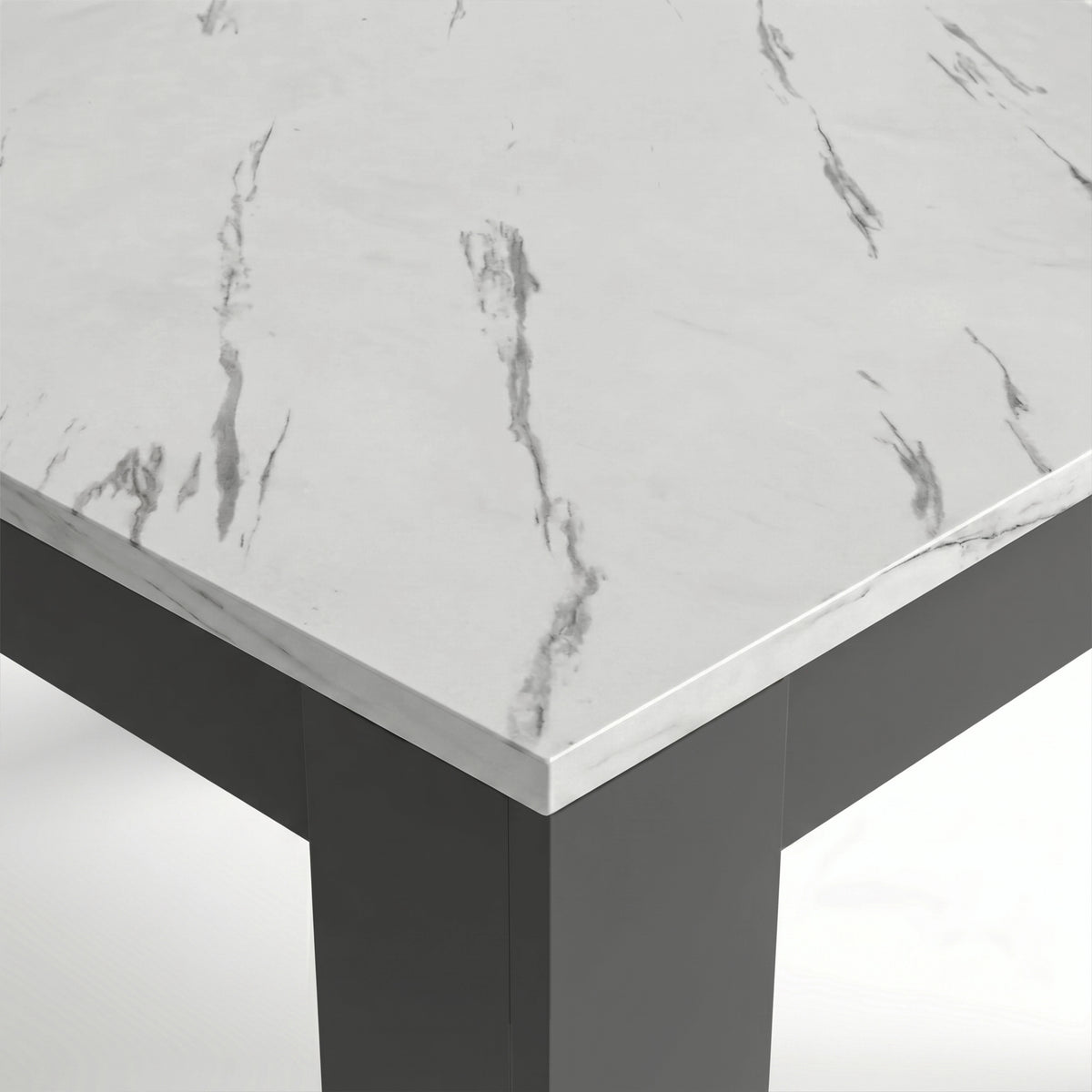[White Marble] Close-up of the marble-effect tabletop corner and thick grey L-shaped leg; fine grey veining crosses the top.