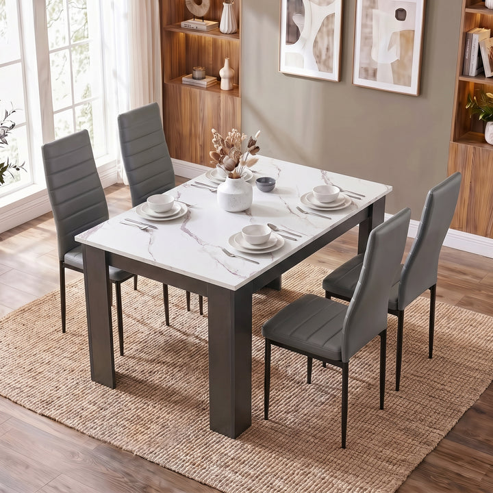 [4 Seater | Grey] White Marble 4 Seater Dining Table and Chairs Set shown from a high angle on a woven rug.