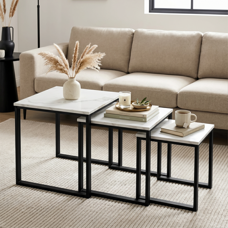 [White Marble] Stackora nest of 3 tables styled as centre table in living room with pampas grass, candle, and mug on beige sofa